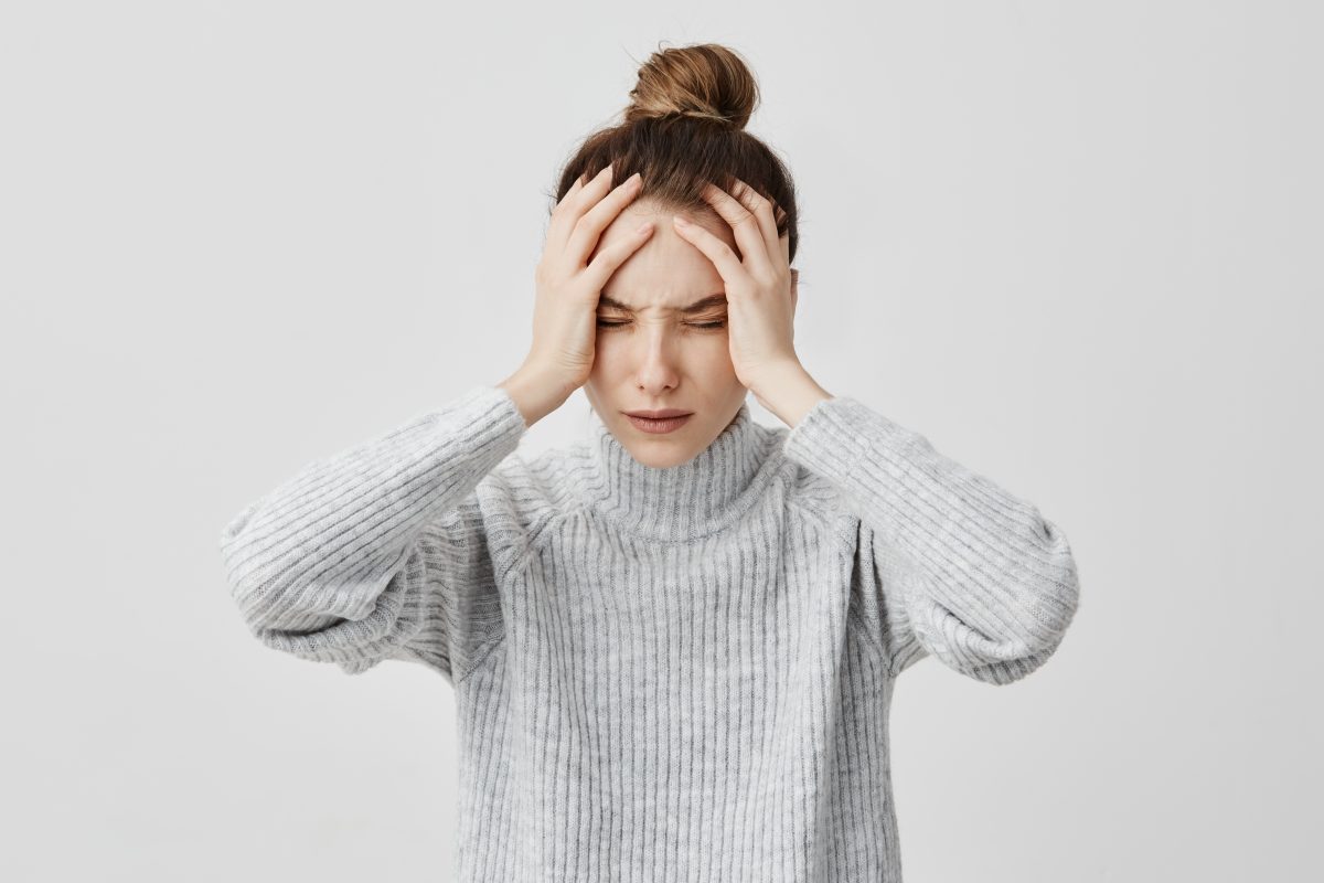 exhausted-young-woman-touching-her-head-with-eyes-closed-female-exchange-worker-suffering-from-unbearable-headache-health-concept-1200x800.jpg